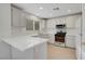 Bright kitchen features white cabinetry, appliances, and countertop with natural light from the window at 2431 Lilac Cove St, Las Vegas, NV 89135