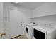 Convenient laundry room featuring a washer, dryer, shelving, and plenty of space at 2431 Lilac Cove St, Las Vegas, NV 89135