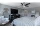 Inviting bedroom with a ceiling fan, a TV over a chest of drawers, and a cozy papasan chair at 2530 Catallo St, Henderson, NV 89044