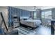 Bright bedroom features a blue patterned accent wall, a comfortable bed, and a cozy reading nook at 2530 Catallo St, Henderson, NV 89044