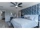 Serene main bedroom with a patterned blue accent wall and plush bedding at 2530 Catallo St, Henderson, NV 89044