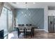 Stylish dining area with modern lighting, a dining table, and access to outdoor patio, near stainless fridge at 2530 Catallo St, Henderson, NV 89044