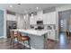 Bright, modern kitchen with a large island, white cabinetry, stainless steel appliances, and stylish pendant lights at 2530 Catallo St, Henderson, NV 89044
