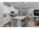 Spacious kitchen island with a sleek white countertop, modern appliances, and decorative pendant lighting at 2530 Catallo St, Henderson, NV 89044