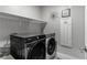Convenient laundry room with modern appliances and storage shelves at 2530 Catallo St, Henderson, NV 89044