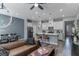 Open-concept living area features a modern kitchen with island and a dining area, all with contemporary finishes at 2530 Catallo St, Henderson, NV 89044