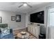 Cozy living room with modern furniture, ceiling fan and large television at 2530 Catallo St, Henderson, NV 89044