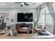Cozy living room featuring a large TV, modern furnishings, and stylish decor for relaxation and entertainment at 2530 Catallo St, Henderson, NV 89044