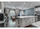 Open-concept living space featuring a kitchen island, dining table, and comfortable living area at 2530 Catallo St, Henderson, NV 89044
