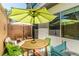 Private patio with outdoor furniture, colorful decor, and shade umbrellas at 2530 Catallo St, Henderson, NV 89044