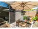 Charming patio with lounge seating, shaded umbrellas, and modern design elements at 2530 Catallo St, Henderson, NV 89044