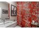 Stylish powder room with red wallpaper featuring playful monkey designs and modern fixtures at 2530 Catallo St, Henderson, NV 89044