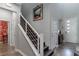 Bright foyer with hardwood stairs, a white handrail, and stylish artwork leading to other rooms at 2530 Catallo St, Henderson, NV 89044