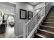 Modern hardwood staircase with metal railing leads to the main living area with neutral decor at 2530 Catallo St, Henderson, NV 89044