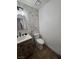 Chic half bathroom boasts marble accent wall, wooden vanity, and modern fixtures at 332 Dockside Ct, Las Vegas, NV 89145