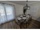 A formal dining area featuring wood flooring, window shutters and modern table and chairs at 332 Dockside Ct, Las Vegas, NV 89145