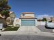 Charming two-story home featuring an attached two-car garage and a well-manicured lawn at 332 Dockside Ct, Las Vegas, NV 89145
