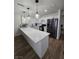 A modern kitchen with stainless steel appliances, quartz countertops, and white cabinetry at 332 Dockside Ct, Las Vegas, NV 89145