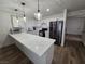 A modern kitchen with stainless steel appliances, quartz countertops, and white cabinetry at 332 Dockside Ct, Las Vegas, NV 89145