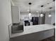 A modern kitchen with stainless steel appliances, quartz countertops, and white cabinetry at 332 Dockside Ct, Las Vegas, NV 89145