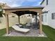 Backyard seating area with pergola, comfortable lounge chairs, and lush artificial turf at 332 Dockside Ct, Las Vegas, NV 89145