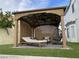 Outdoor seating area with pergola, comfortable lounge chairs, and lush artificial turf at 332 Dockside Ct, Las Vegas, NV 89145