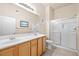 Well-lit bathroom with double sinks and a glass-enclosed shower stall, offering a clean and functional space at 3451 Desert Cliff St # 103, Las Vegas, NV 89129