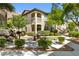 Stunning two-story building with a stone picnic bench, beautiful landscaping and a gorgeous mountain view at 3451 Desert Cliff St # 103, Las Vegas, NV 89129