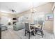 Inviting dining area with a round table, fireplace, natural light, and seamless access to the living room at 3451 Desert Cliff St # 103, Las Vegas, NV 89129