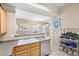 Kitchen view with cabinets, lighting, stainless dishwasher, and countertops that open to the living space at 3451 Desert Cliff St # 103, Las Vegas, NV 89129
