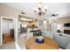 Open concept living space with kitchen view, dining area, and cozy living room with neutral paint colors throughout at 3451 Desert Cliff St # 103, Las Vegas, NV 89129