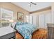 Bright main bedroom featuring a ceiling fan, wood-look floors, and large window providing natural light at 3451 Desert Cliff St # 103, Las Vegas, NV 89129