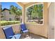 Relaxing patio with two chairs and tranquil views of the surrounding greenery and community landscape at 3451 Desert Cliff St # 103, Las Vegas, NV 89129