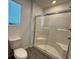 Bathroom featuring a glass-enclosed shower with built-in seating and tiled walls at 3493 Arcadian King Ave, Las Vegas, NV 89106