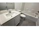 This bathroom features a white vanity, a toilet, and a tub with tiled walls at 3493 Arcadian King Ave, Las Vegas, NV 89106