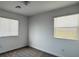 This bedroom features natural light from two windows and carpet flooring at 3493 Arcadian King Ave, Las Vegas, NV 89106