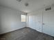 This bedroom features natural light, carpet flooring, a closet, and a door at 3493 Arcadian King Ave, Las Vegas, NV 89106