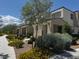 Inviting home exterior with attractive landscaping and manicured bushes under a sunny sky at 3493 Arcadian King Ave, Las Vegas, NV 89106