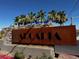 Welcoming Arcadia community sign with stone accents and lush palm trees in the background at 3493 Arcadian King Ave, Las Vegas, NV 89106