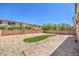 Expansive backyard with a mix of gravel, brick pavers, and artificial grass at 4016 Gaster Ave, North Las Vegas, NV 89081