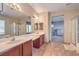 Spacious primary bathroom features a double sink vanity, a separate shower, and a large soaking tub at 4016 Gaster Ave, North Las Vegas, NV 89081