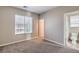 This standard bedroom features neutral carpet and paint, as well as multiple windows for natural light at 4016 Gaster Ave, North Las Vegas, NV 89081