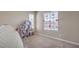 A bedroom features neutral paint, carpet, two large windows, and dollhouse decor at 4016 Gaster Ave, North Las Vegas, NV 89081