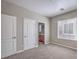 This bedroom has neutral paint, multiple doors, and a view into a bathroom at 4016 Gaster Ave, North Las Vegas, NV 89081