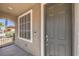 View of a grey-colored front door with window at 4016 Gaster Ave, North Las Vegas, NV 89081