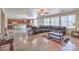 Large open-concept living room flowing into kitchen with modern design and tile flooring at 4016 Gaster Ave, North Las Vegas, NV 89081