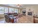 Comfortable living room featuring a fireplace, large windows, and an oversized leather couch at 4016 Gaster Ave, North Las Vegas, NV 89081