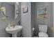 Bathroom with a decorative mirror, sink, toilet and framed artwork at 4215 Macadamia Dr, Las Vegas, NV 89115