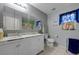 Bathroom featuring double sinks, tiled floors, a toilet, mirror, and vanity lighting at 4215 Macadamia Dr, Las Vegas, NV 89115