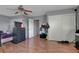 Bedroom with wood flooring, a ceiling fan, closet, and a light gray color scheme at 4215 Macadamia Dr, Las Vegas, NV 89115